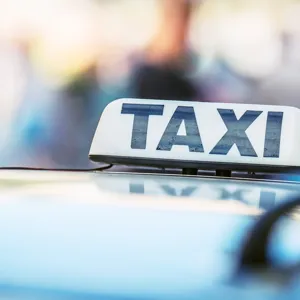 A close up of a taxi plate